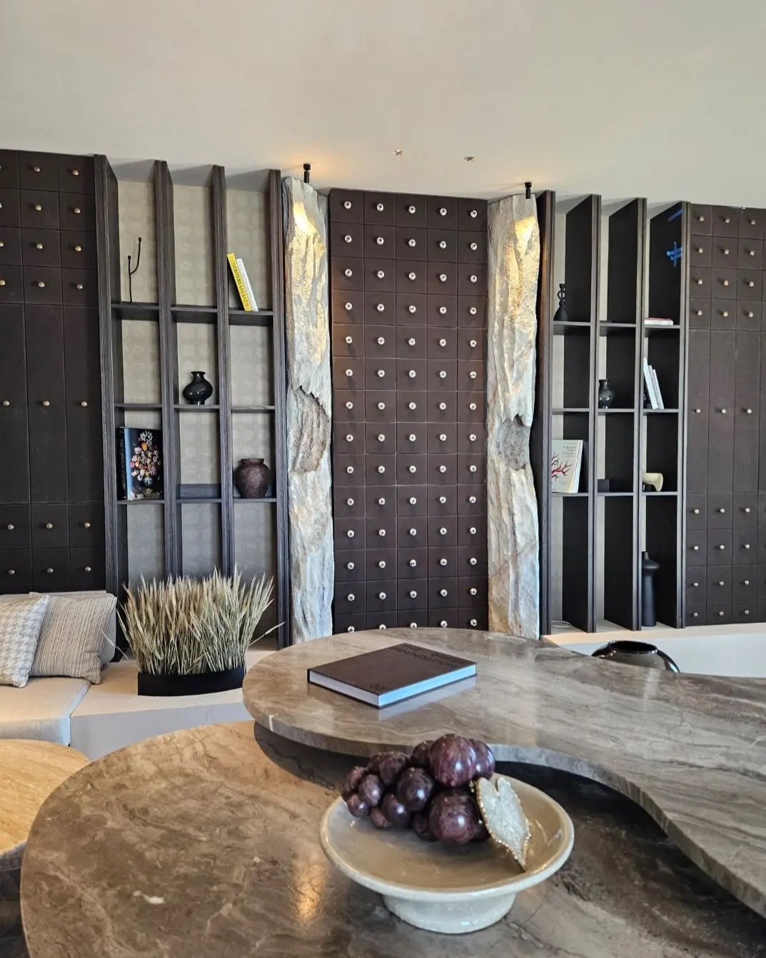 A curved stone counter in the finished lounge at Oroséa, set against dark panelled cabinetry
