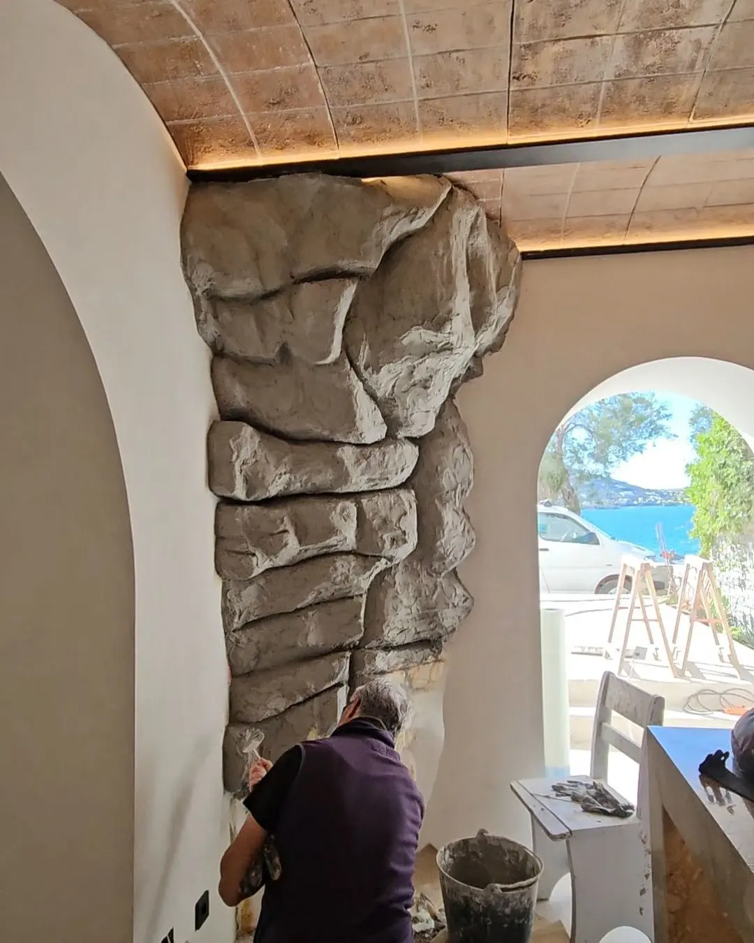 A sculpted rock arch framing the view through to the sea