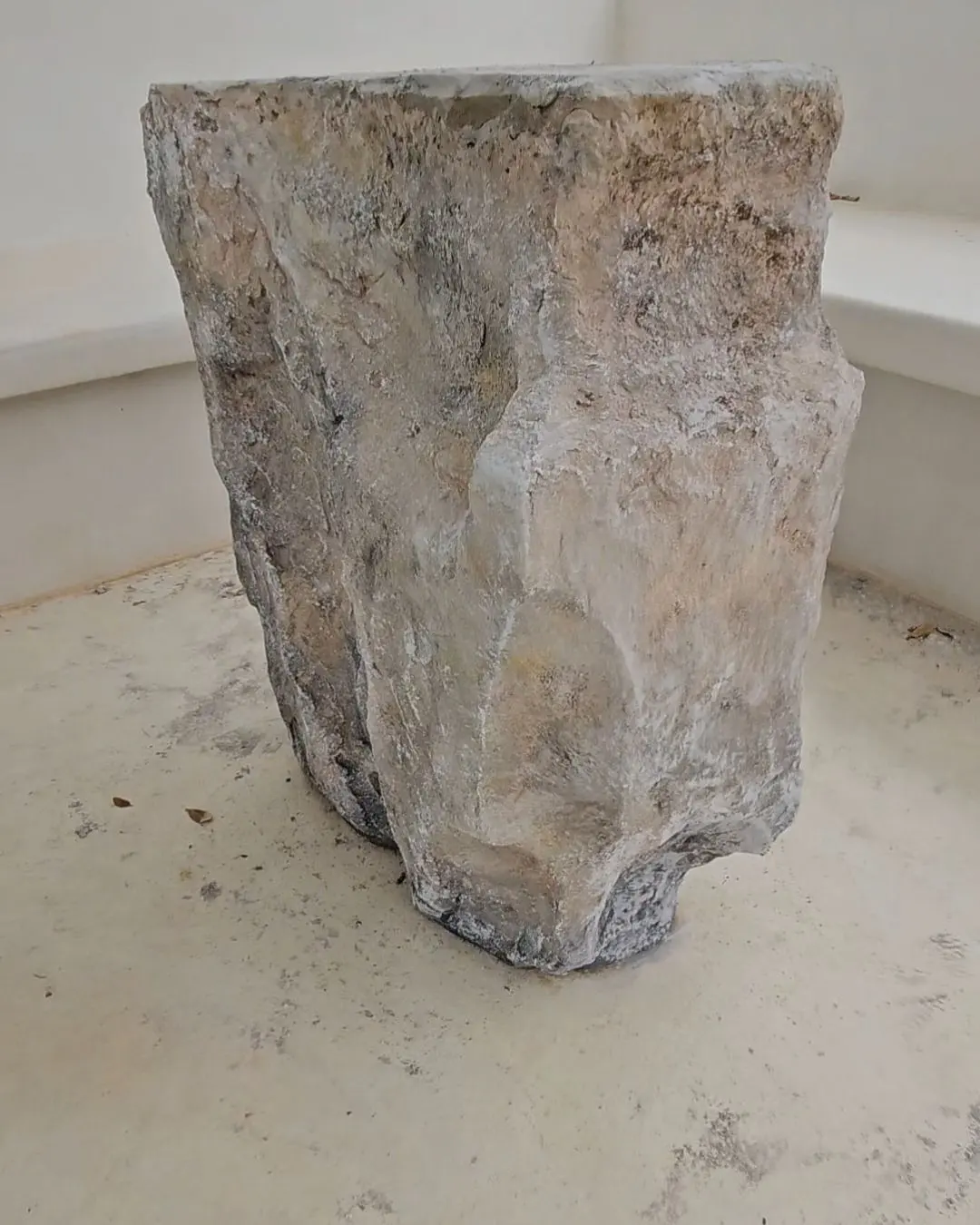 The pedestal base seen against the terrace floor