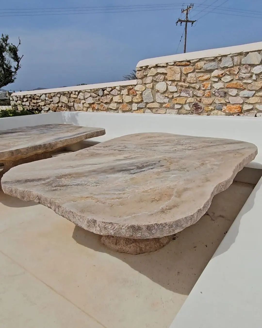 The stone table against the boundary wall, the hills beyond