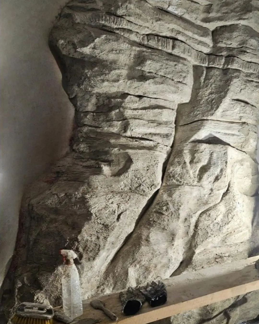 The rock wall part-way through construction, tools still in place